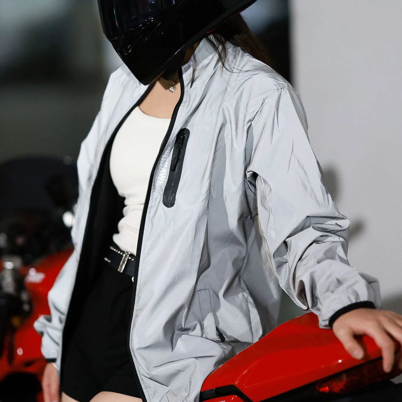 Silver waterproof polyester windbreaker jacket with long sleeves shown on a hanger.