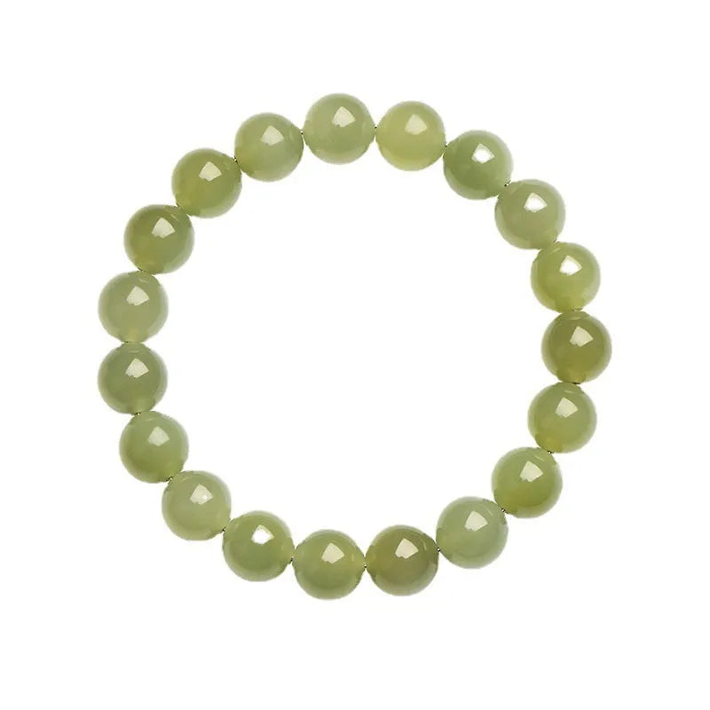 A polished Hetian jade bead bracelet in deep clear water colour on a wrist.