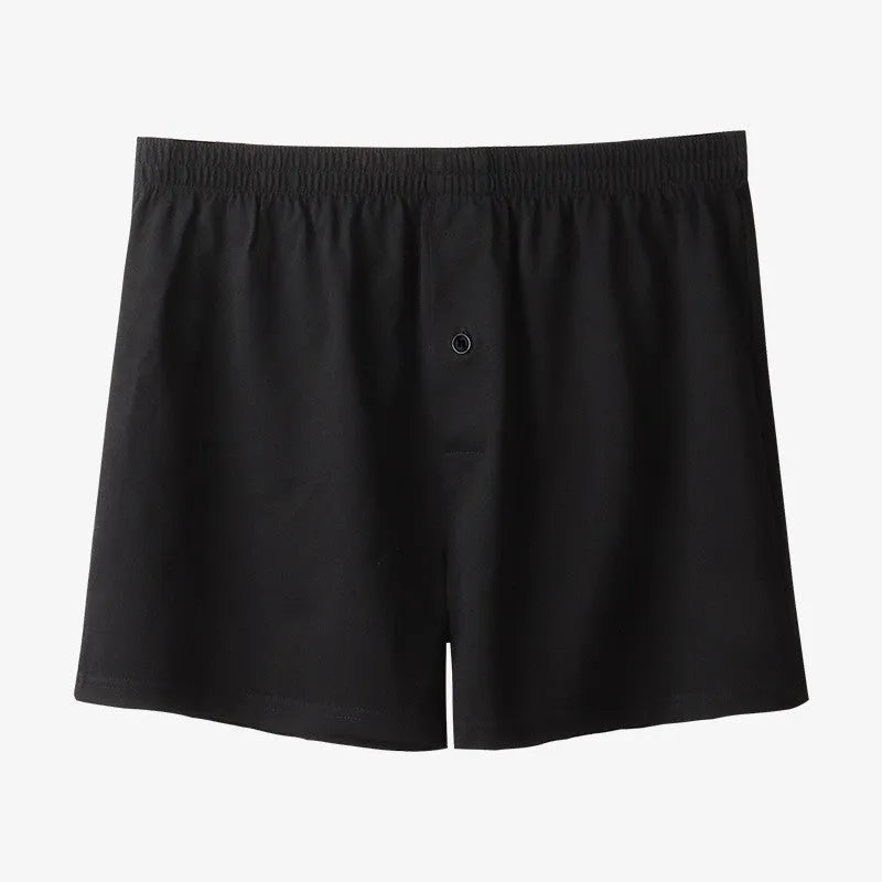 Men's light grey high-waist cotton loose boxer shorts laid flat.