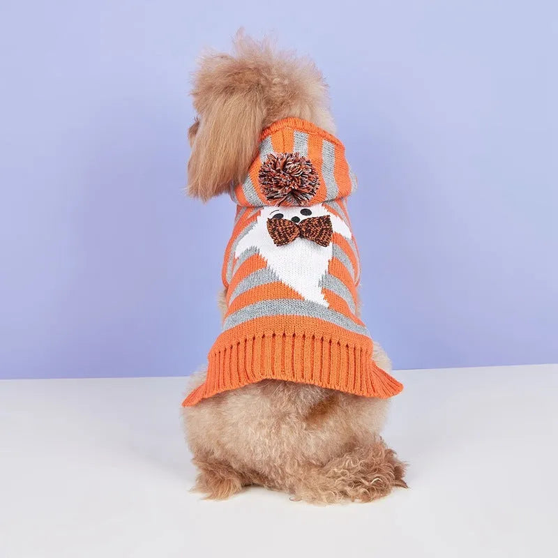 Orange Halloween knitted pet sweater with striped pattern and hooded design featuring fur ball decoration