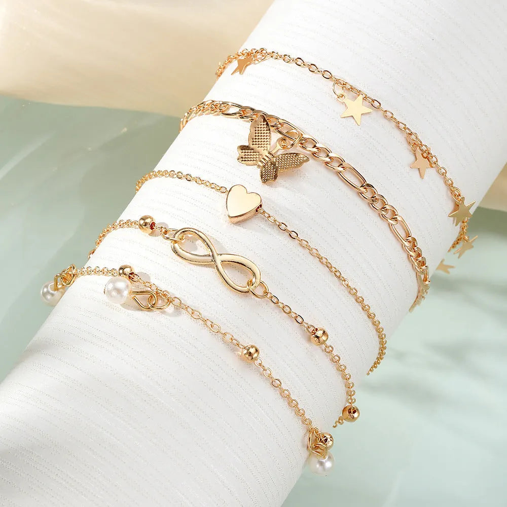 Butterfly pearl heart design four-piece alloy anklet set for women with multi-layer styling options