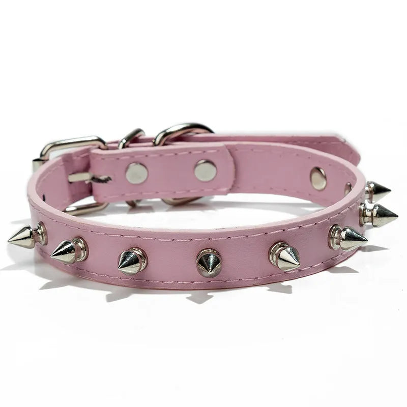 Close-up of a studded black PU leather dog collar with metal spikes and a silver alloy buckle fastener.