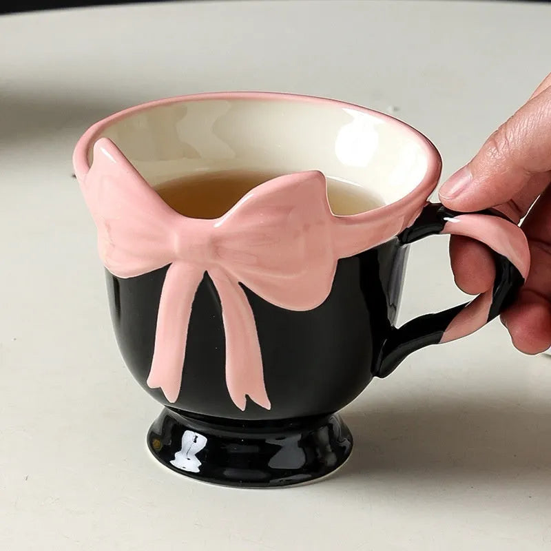 Ceramic mug with a cute girl heart bow design in white powder and black pink colours.