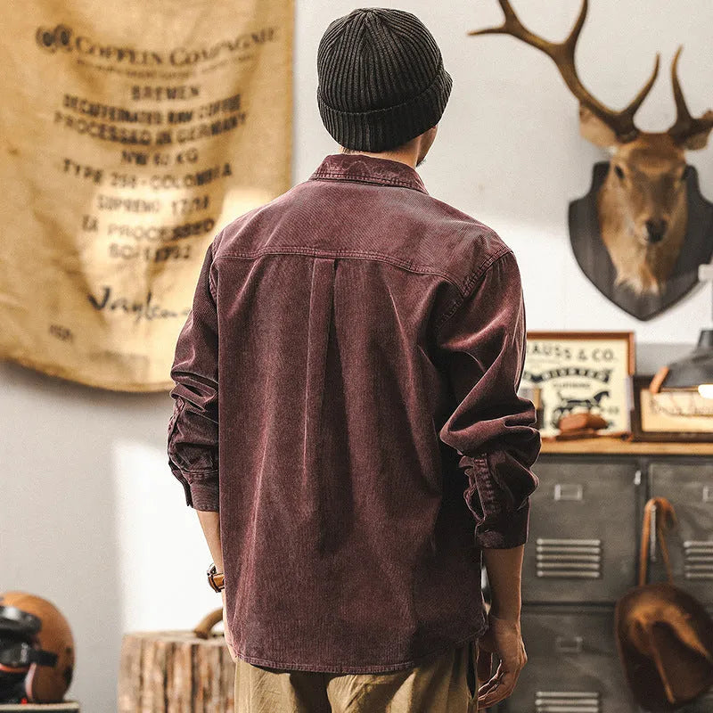A man's loose-fit retro corduroy shirt jacket in red, featuring long sleeves and a button-front design.