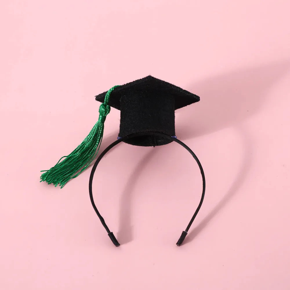 Pet wearing a British-style graduation cap hair band and matching bow tie