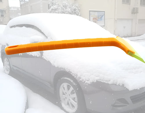 Yellow plastic car snow shovel for ice removal, 32cm length, on a dark background
