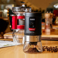 Portable black hand crank coffee grinder with manual operation for travel and home use