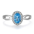 Geometric women's jewellery set in sterling silver with blue topaz gems, showing necklace, earrings, ring, and pendant.