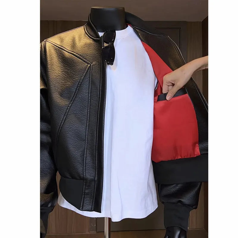 Man wearing a long black PU leather jacket with a tight fit and light business style.