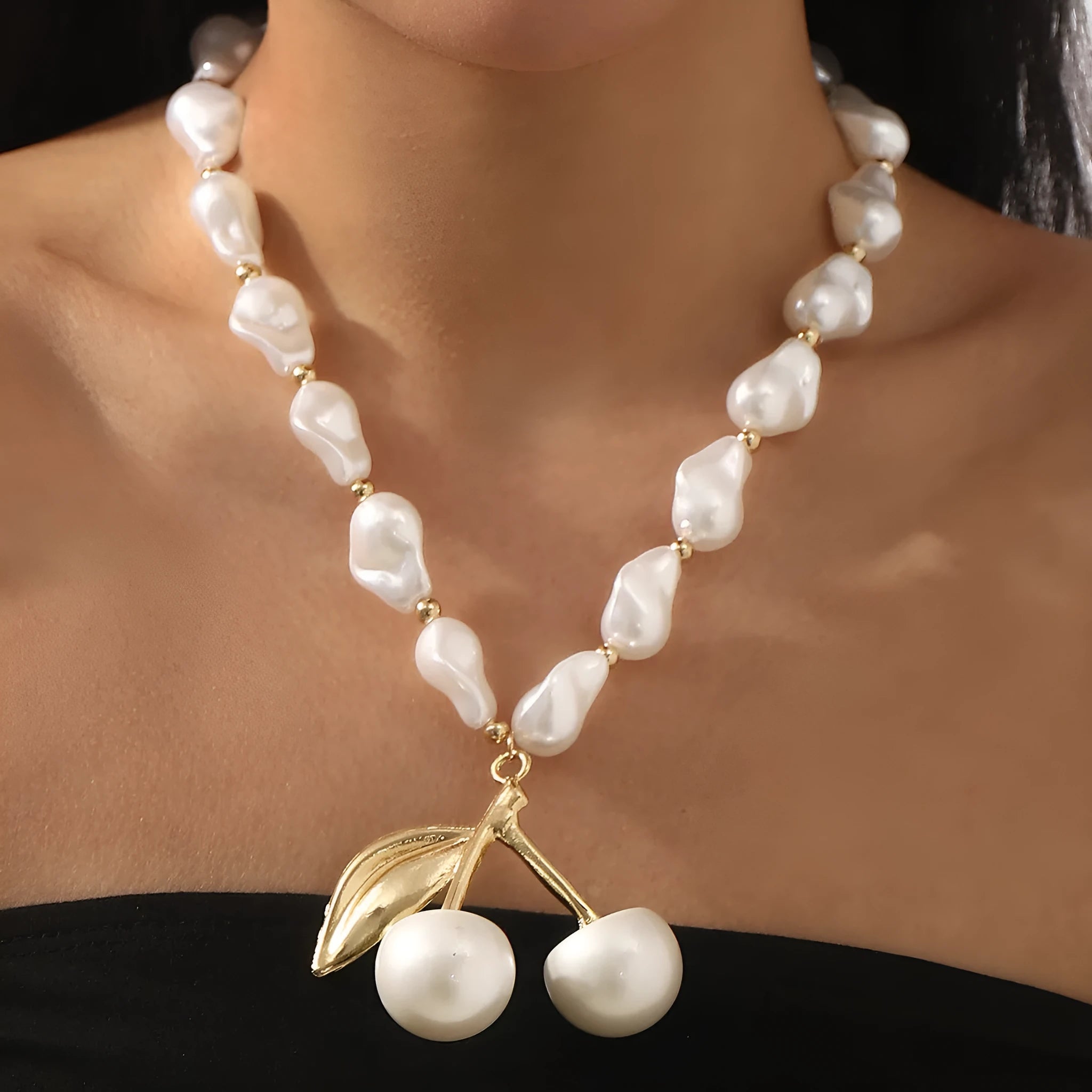Gold irregular cherry fruit pendant on a white imitation pearl chain necklace, adjustable from 51 to 60 cm.