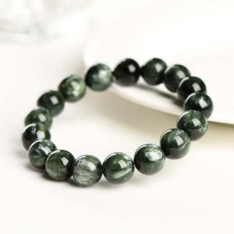 Grade 7A Green Dragon Crystal bracelet with round beads and ruyi design on a wrist.