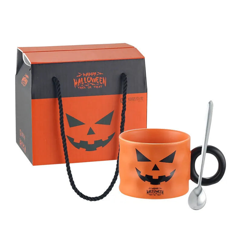 Orange ceramic pumpkin mug with handle on gift box with dessert spoon
