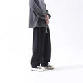 Cotton men's loose wide leg drawstring trousers in black and brown straight leg style with mid waist