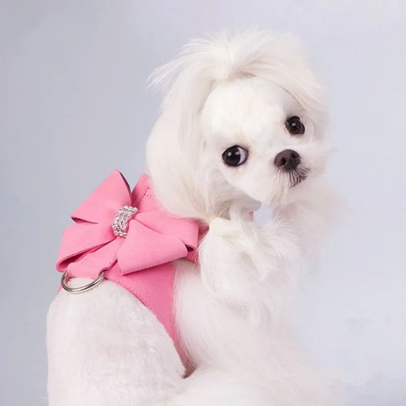 Cute pink bowknot chest strap for a small dog on a white background.