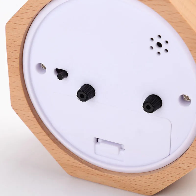 Polygonal beech wood luminous alarm clock with hexagonal shape in brown white finish on nightstand