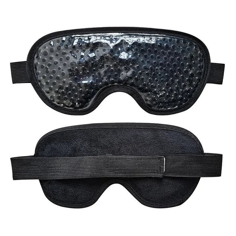 White portable rechargeable eye compress and atomisation device with included eye mask on a table.