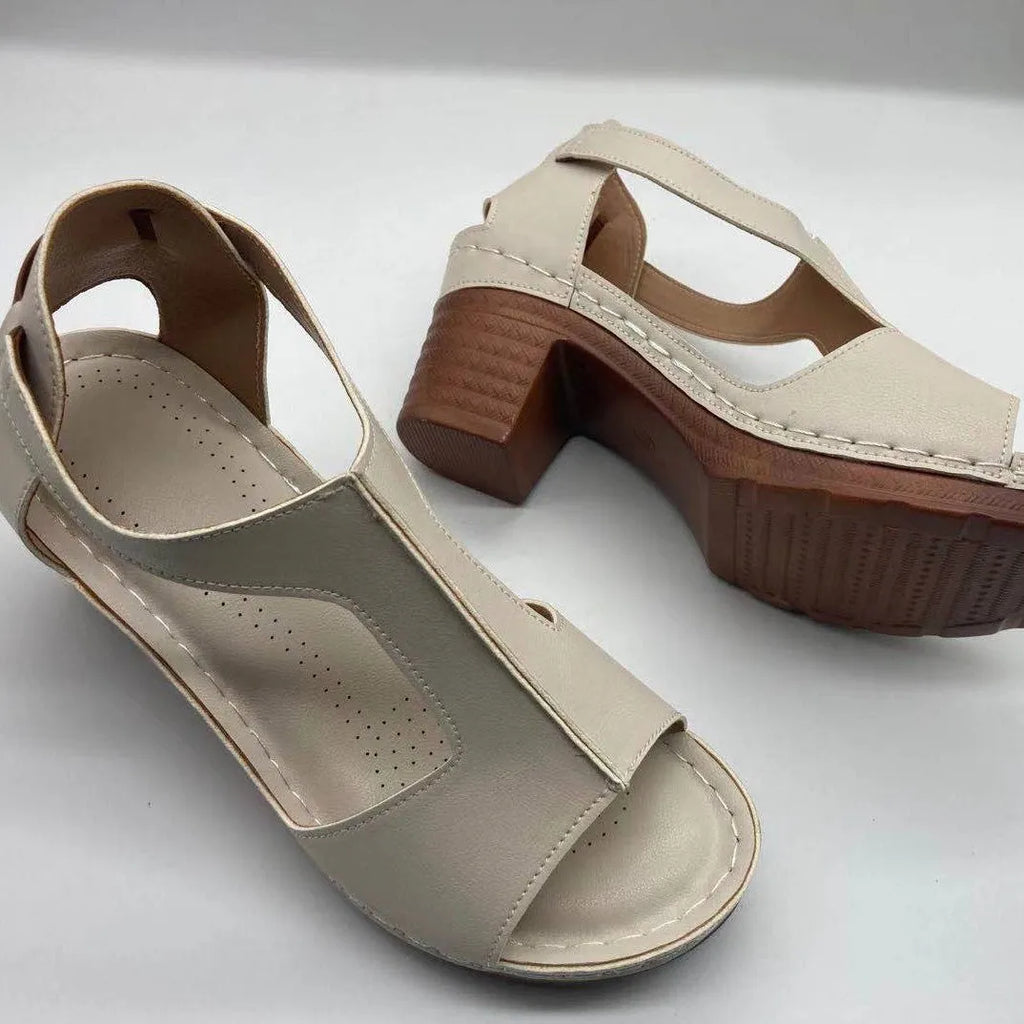 Women's white peep toe wedge sandals with a buckle strap on a slingback heel.