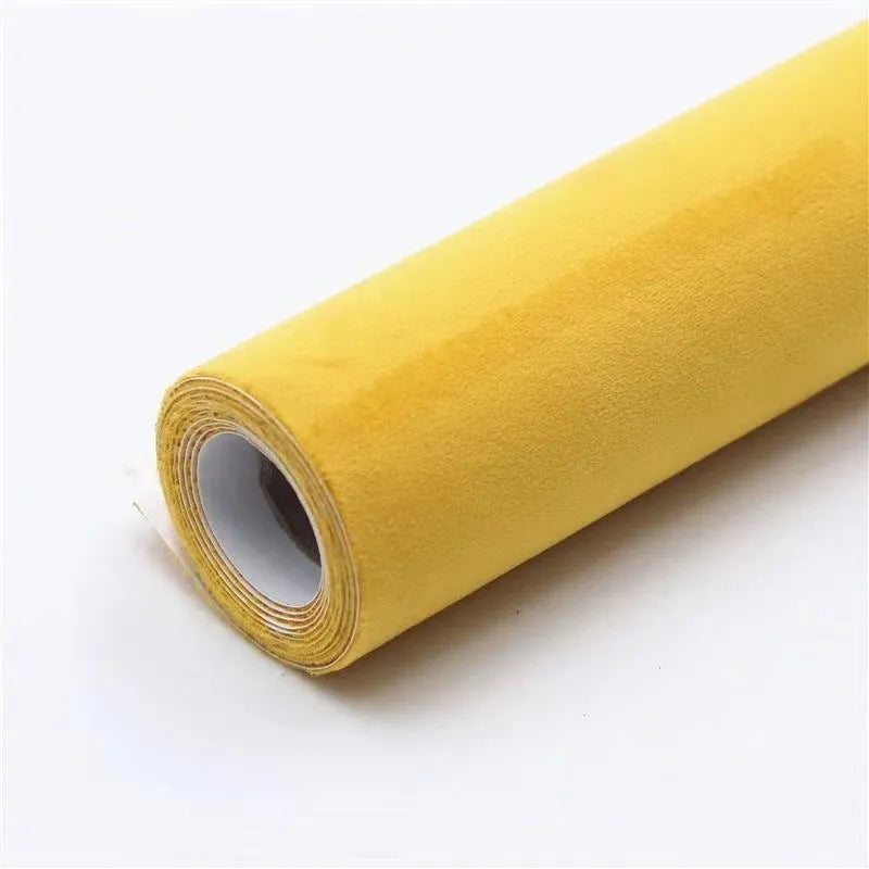 Roll of self-adhesive leather suede fabric in BMW brown colour next to a car dashboard.