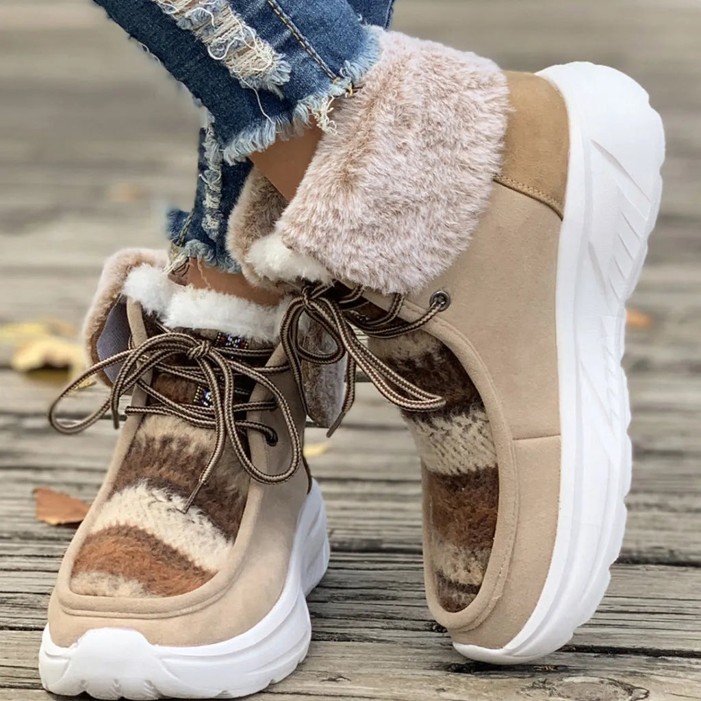 Beige women's mid-top suede snow boots with lace-up front and a thick rubber sole.