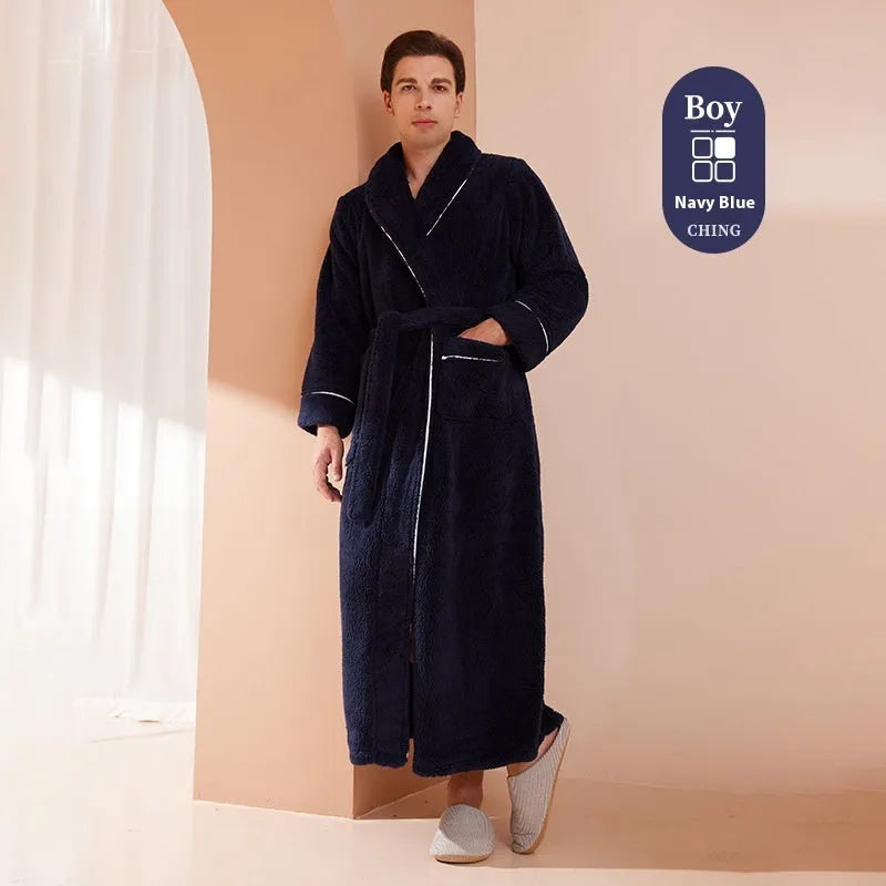 A man and woman wearing matching navy blue thick flannel bathrobes, showcasing the wrap-around design and plush fabric.