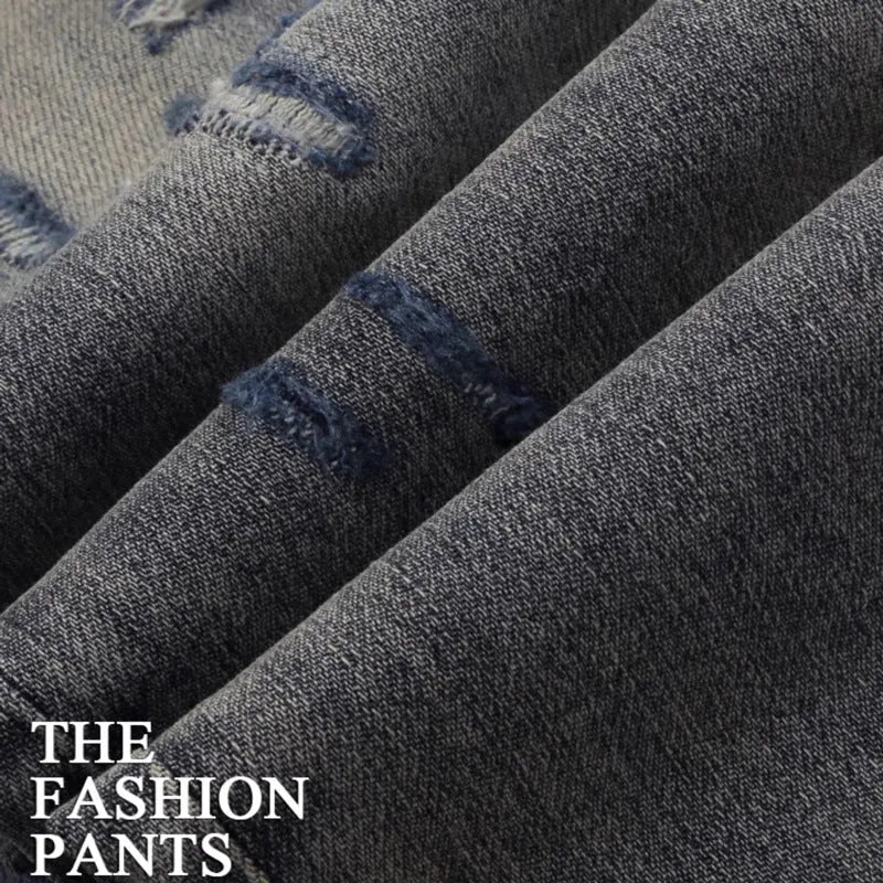 Old colour slim fit jeans with washed-out finish, patch details, and embroidery on cotton fabric.