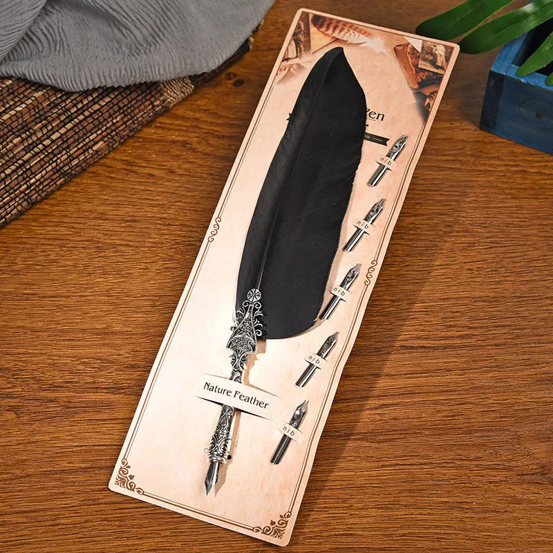 Vintage feather dip pen with zinc alloy holder in assorted colours on a wooden desk