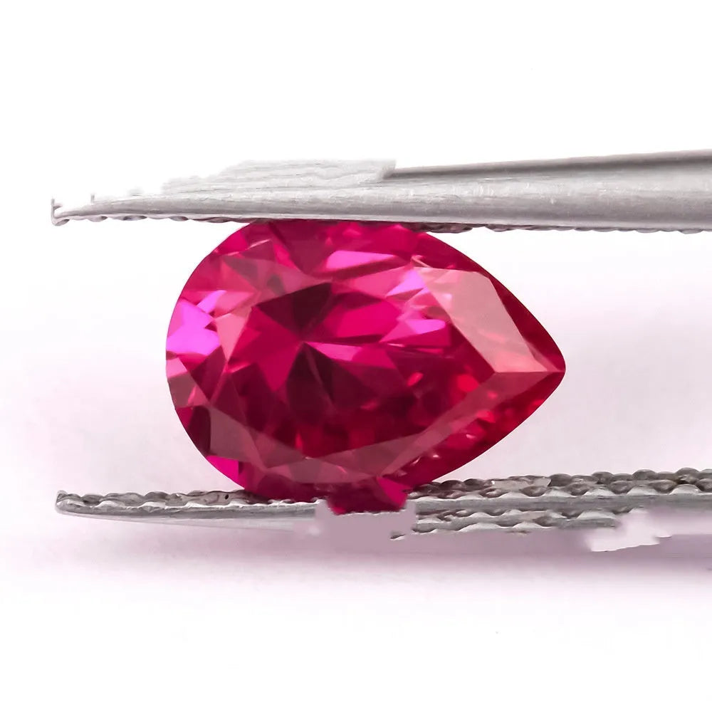 A loose, faceted artificial ruby gemstone in a deep pigeon blood red colour.