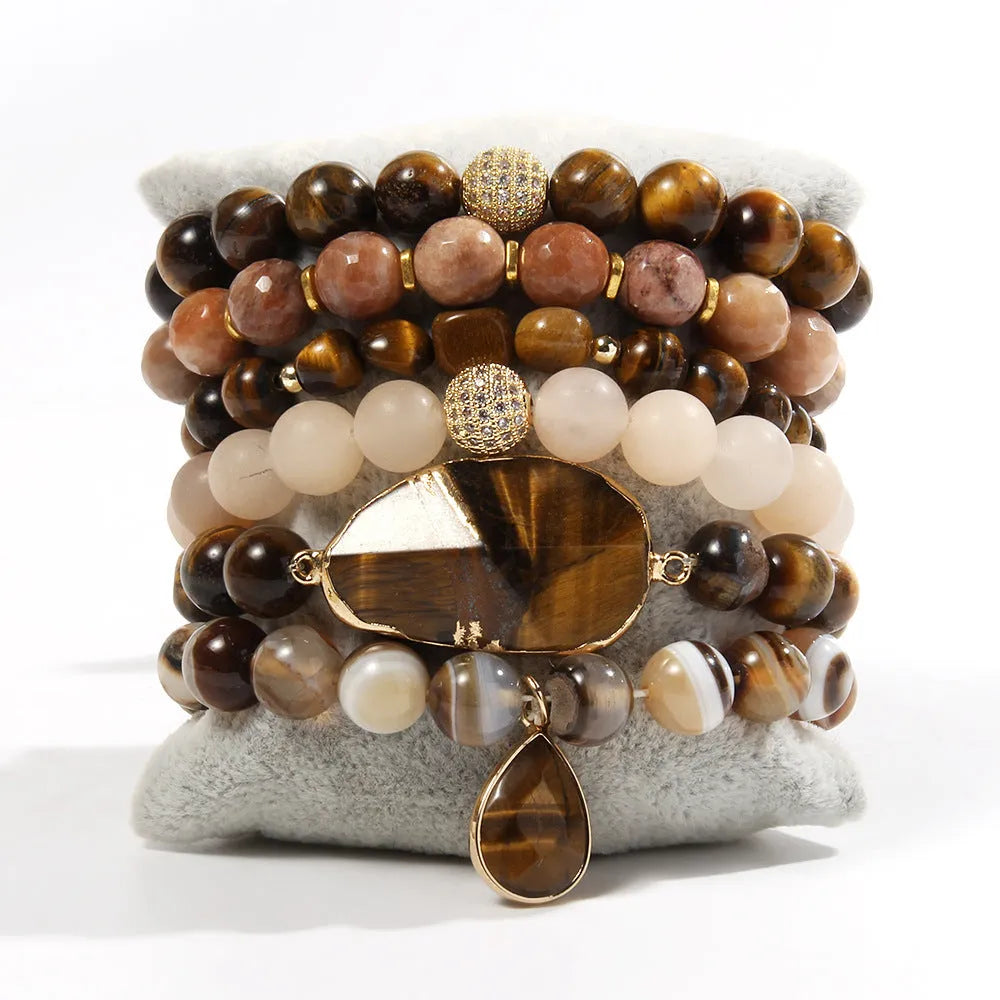Women's glass beaded stretch bracelet set in brown with natural stone and zircon beads on a white surface