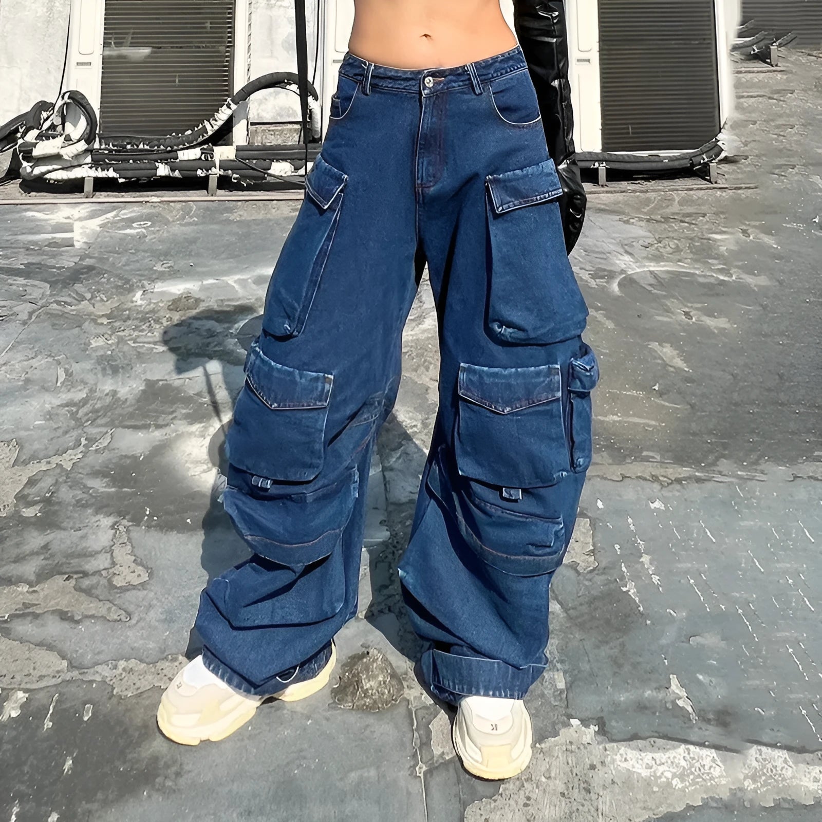 Dark blue distressed women's wide-leg jeans with a high waist and multiple pockets on a neutral background.