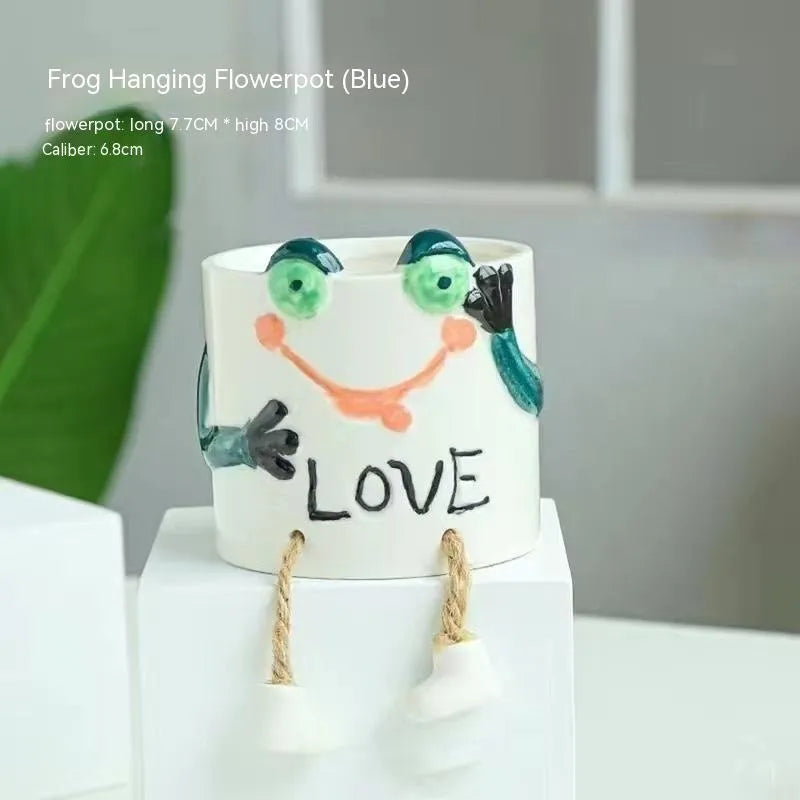Ceramic hanging foot flowerpot in a cartoon style, shown as a desktop planter for succulent plants.