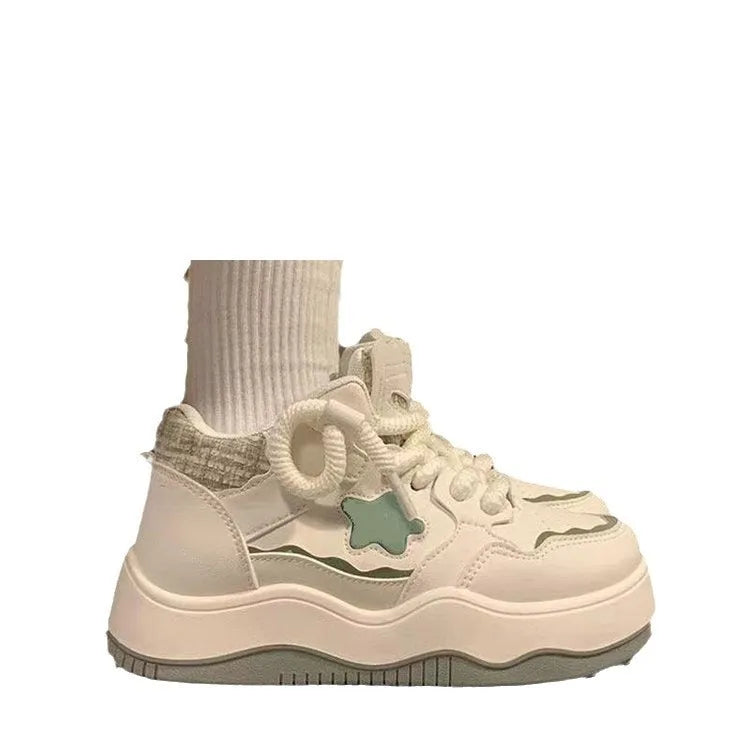 Women's green patent leather platform sneakers with round toe and lace-up closure