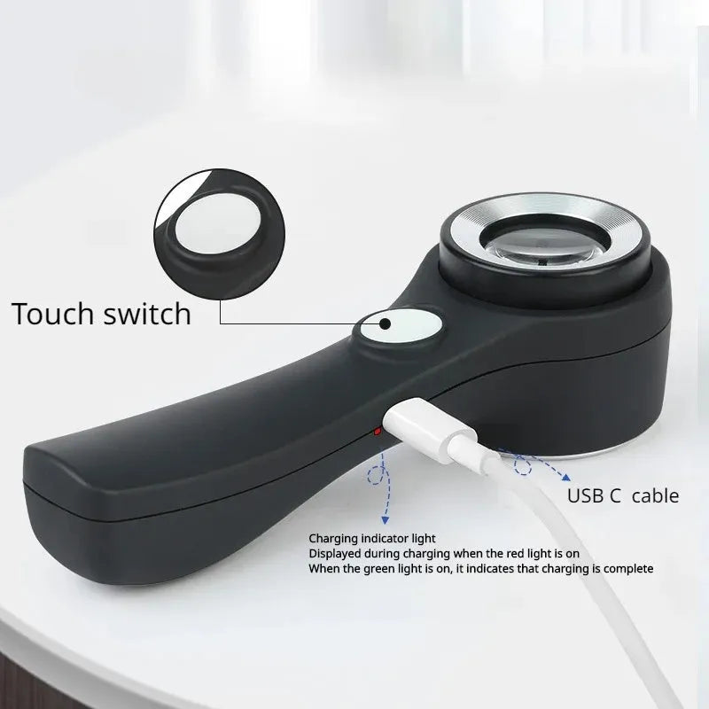 Black and silver electronic magnifying glass for jewellery appraisal with 30X lens and USB C cable.