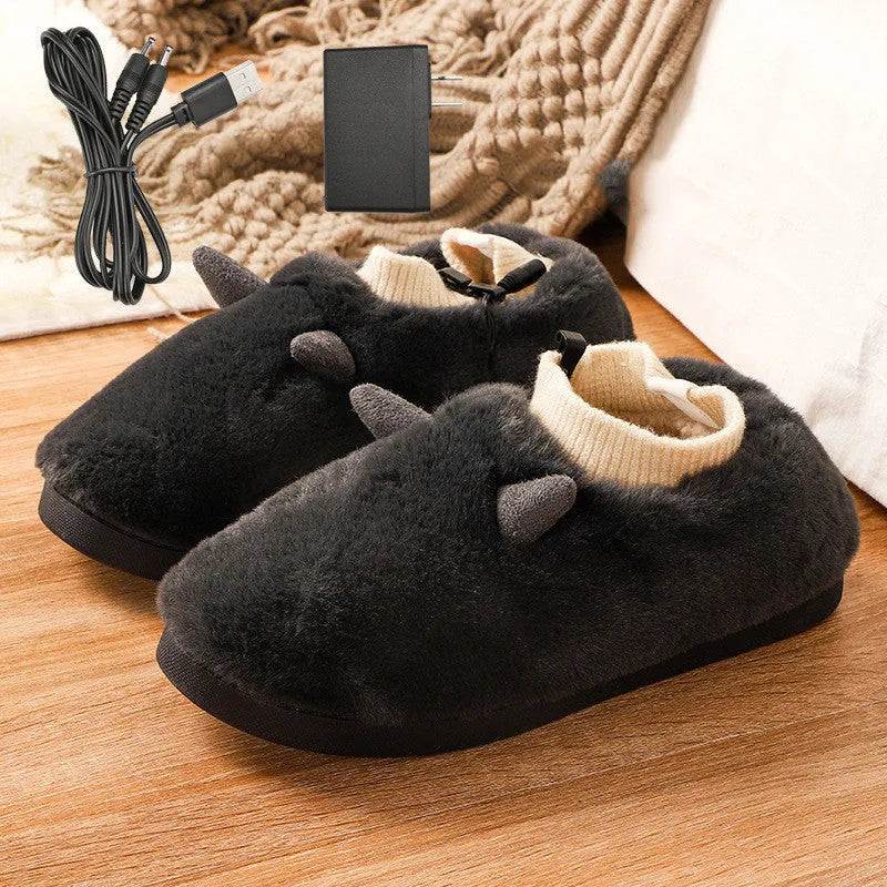 USB electric foot warmer slippers in grey with a connected USB cable on a wooden floor.