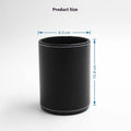 Small round black leather pen holder on a desk