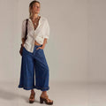 Women's wide-leg cropped lace jeans in dark blue, high waist, loose fit, with zipper and button details