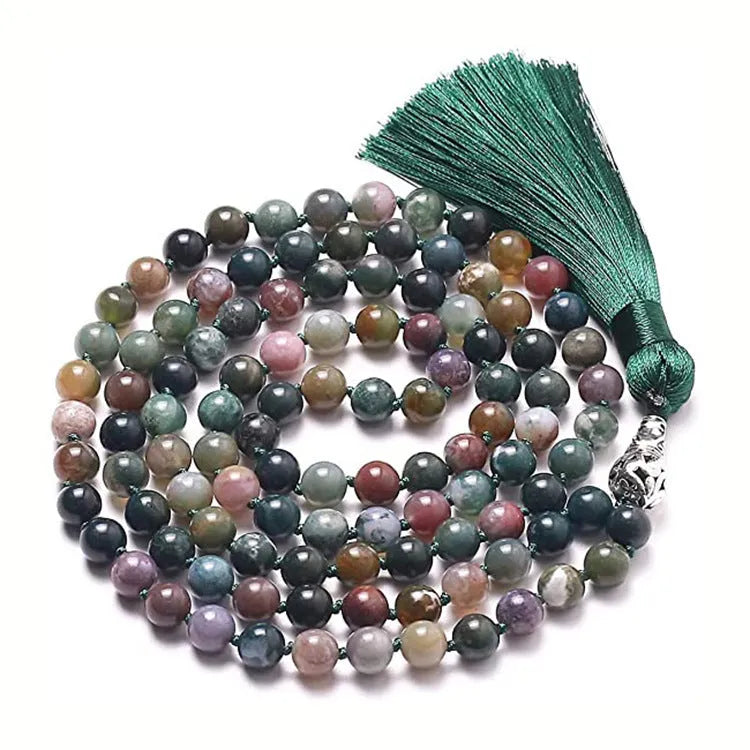 Long agate and amethyst gemstone tassel necklace with geometric pendant on a model.
