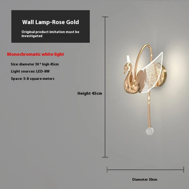 Gold modern minimalist swan-shaped LED wall lamp with an acrylic shade on a wall.