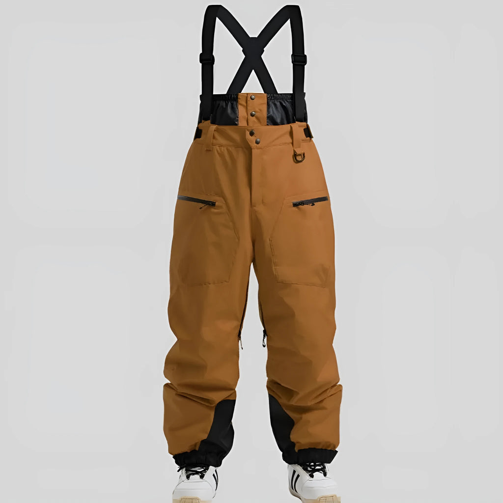 Man wearing black waterproof ski pants with adjustable ankle straps.