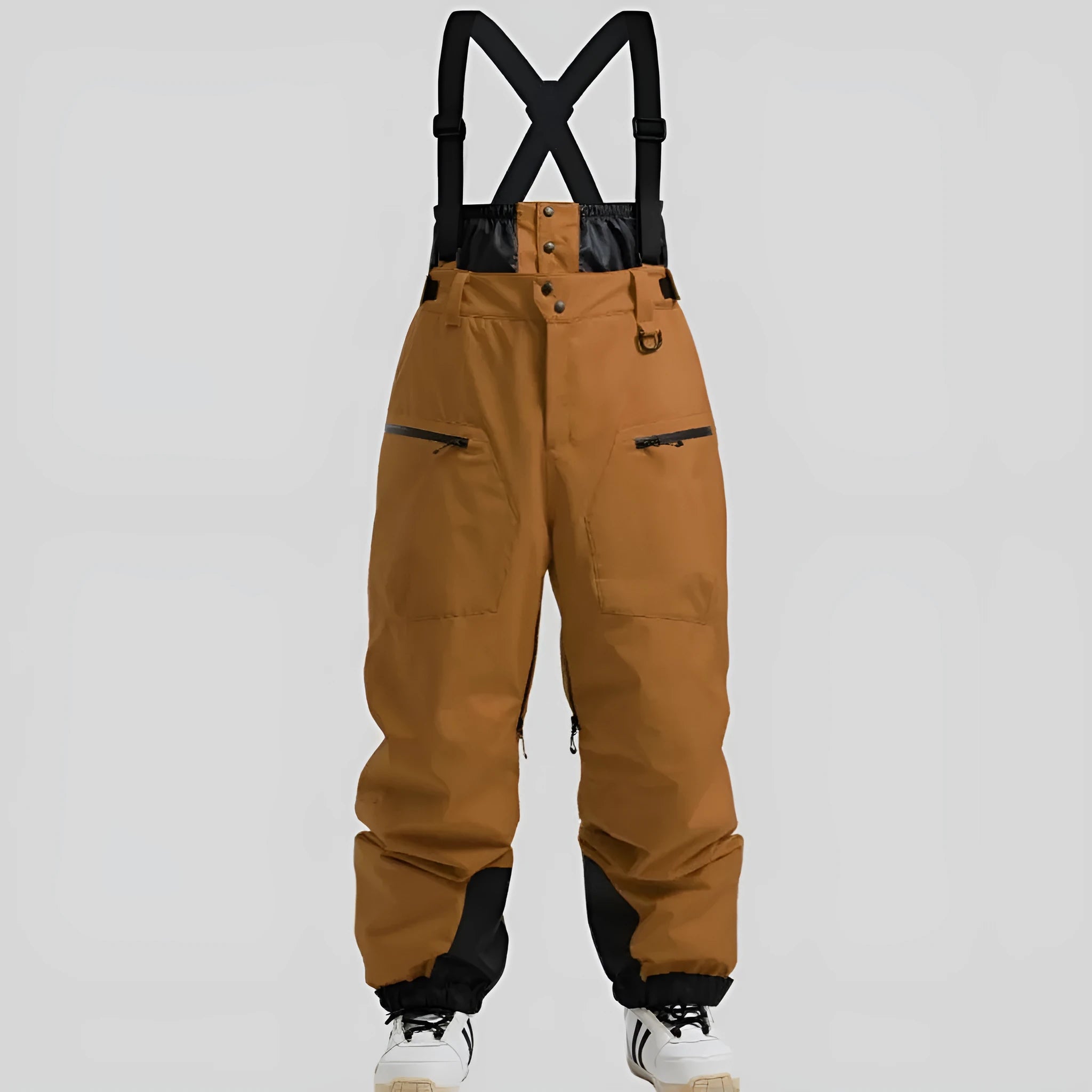 Man wearing black waterproof ski pants with adjustable ankle straps.