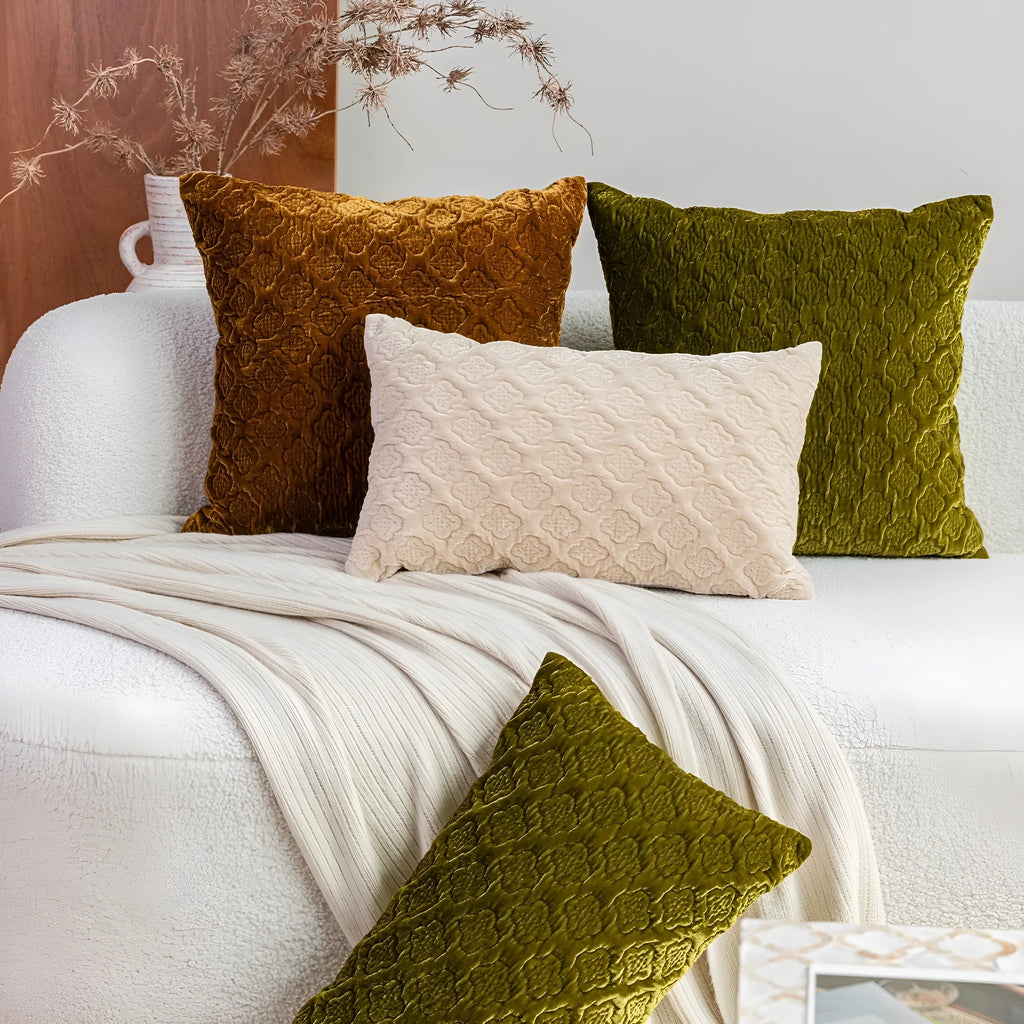 Brown gold antique style quilted square cushion with three-dimensional texture on a sofa.