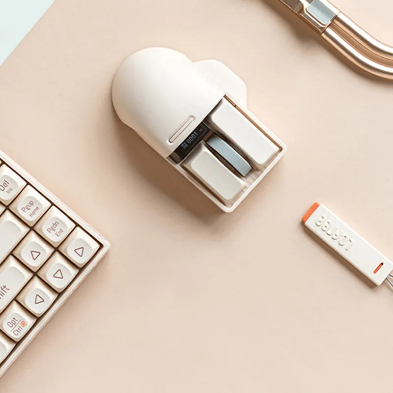 Xiaoqiao Tofu coloured three-mode wireless mouse with ergonomic shape on a desk.