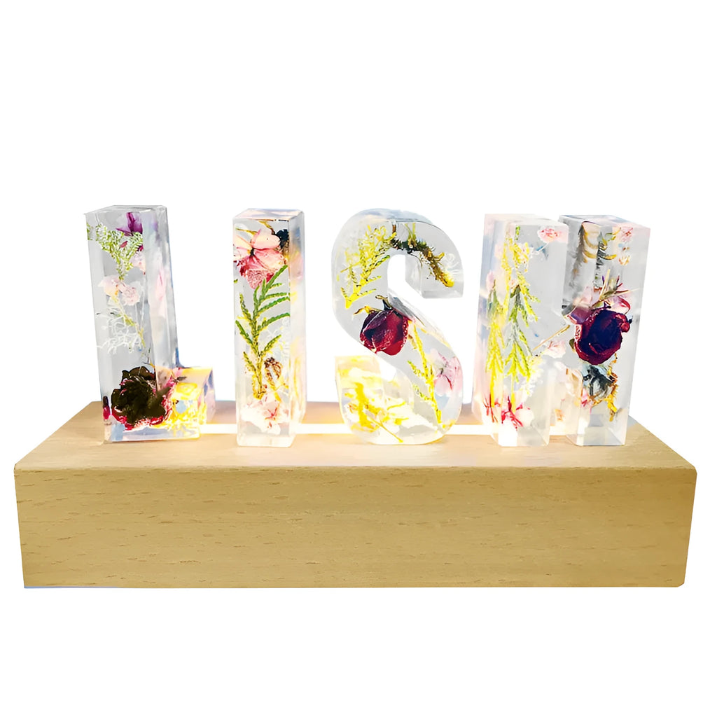 White dried flower alphabet night light in crystal epoxy with real flowers, available in 3 to 8 letters.