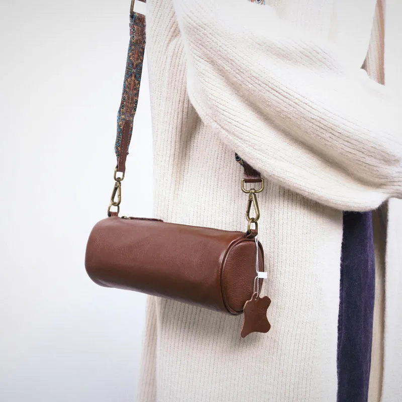 Top layer cowhide leather round single-shoulder bag in caramel brown with wide strap and sewing thread details
