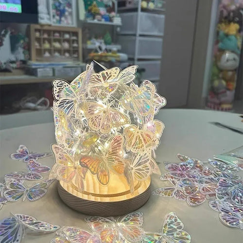 Butterfly night light with glass lampshade on raw wood base for bedroom ambience lighting