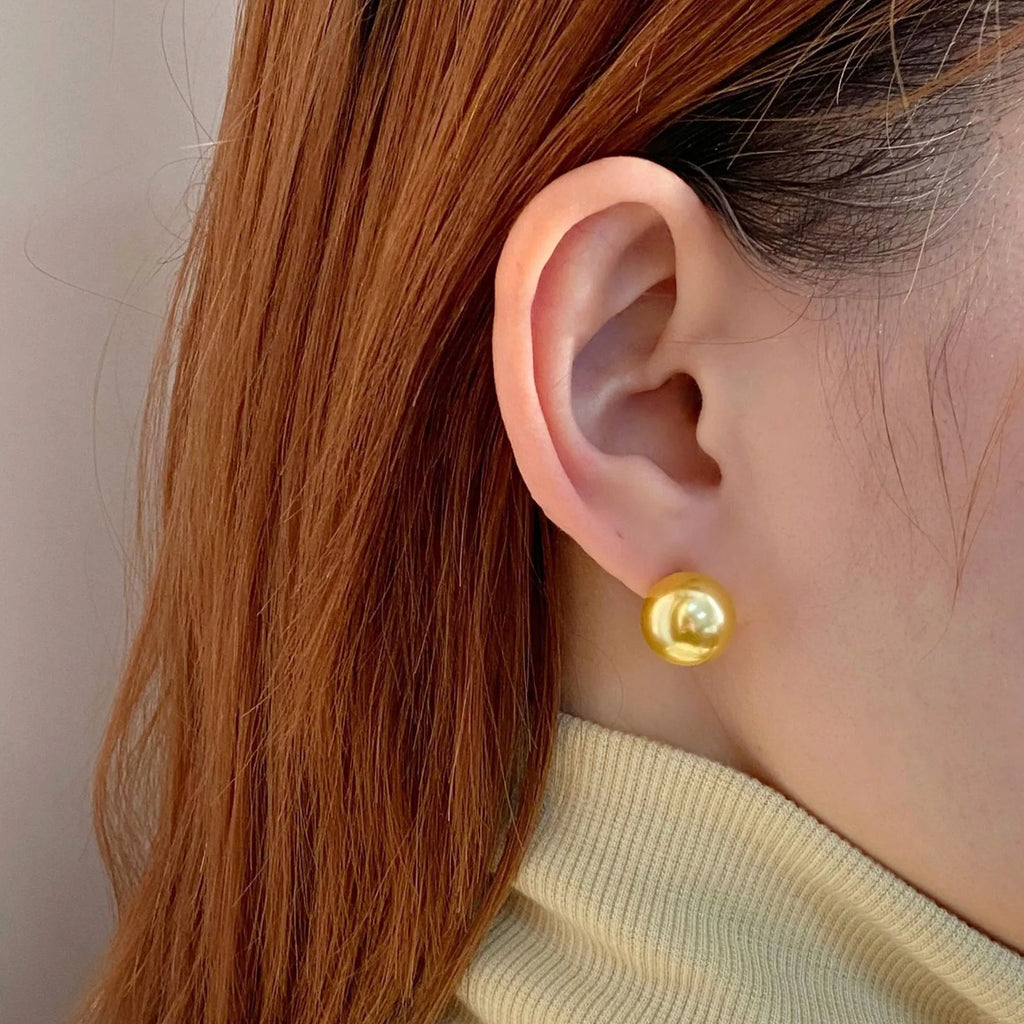 Large geometric pearl stud earrings for women with an eight-point star detail on a silver setting.