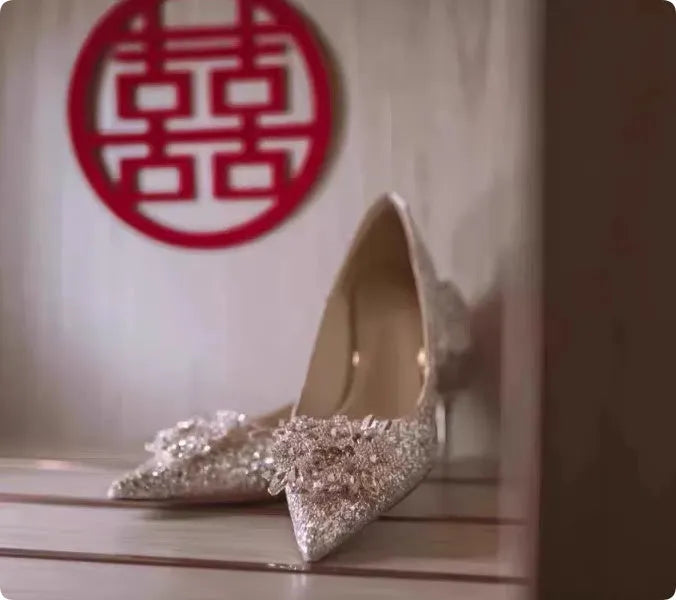 Champagne coloured pointed toe bridal shoes with rhinestone flower pattern and fine heel.