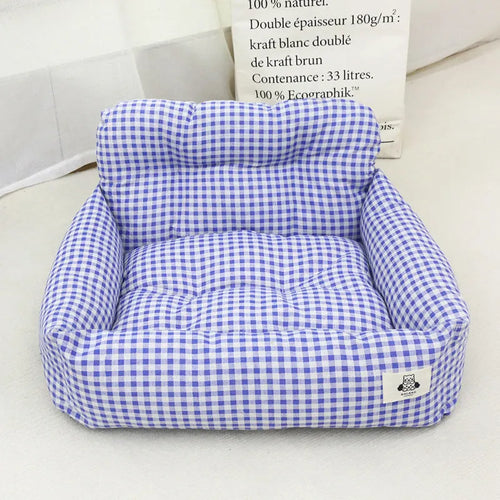 Grey and blue plaid car-mounted dog travel nests showing small and large size options
