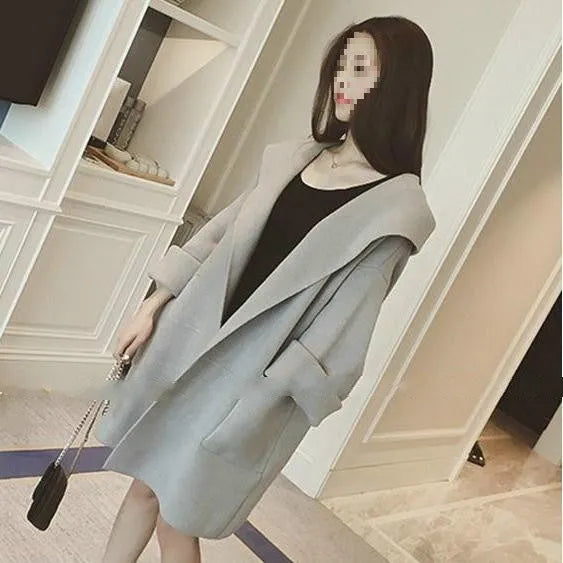 A grey plus size women's loose thin coat with long sleeves and lace detail on a hanger.
