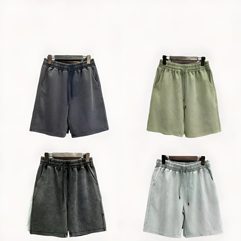 Men's charcoal black cotton shorts with a distressed finish and straight loose leg.