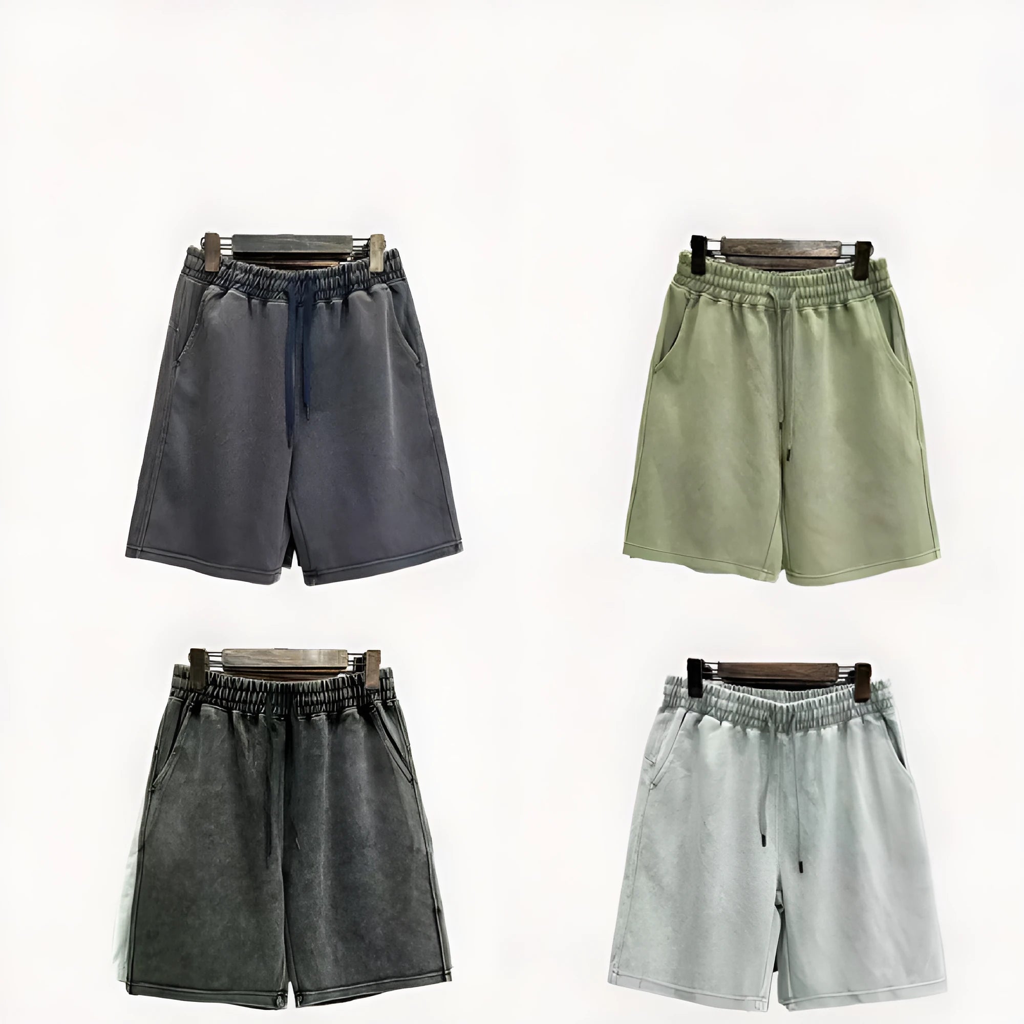 Men's charcoal black cotton shorts with a distressed finish and straight loose leg.